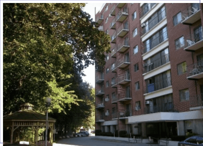 A view of an apartment building from the street.