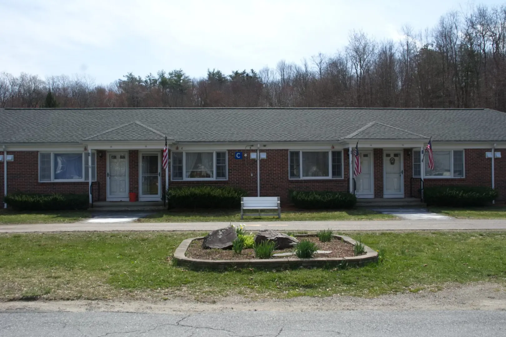 A motel with two identical buildings and a flower bed.