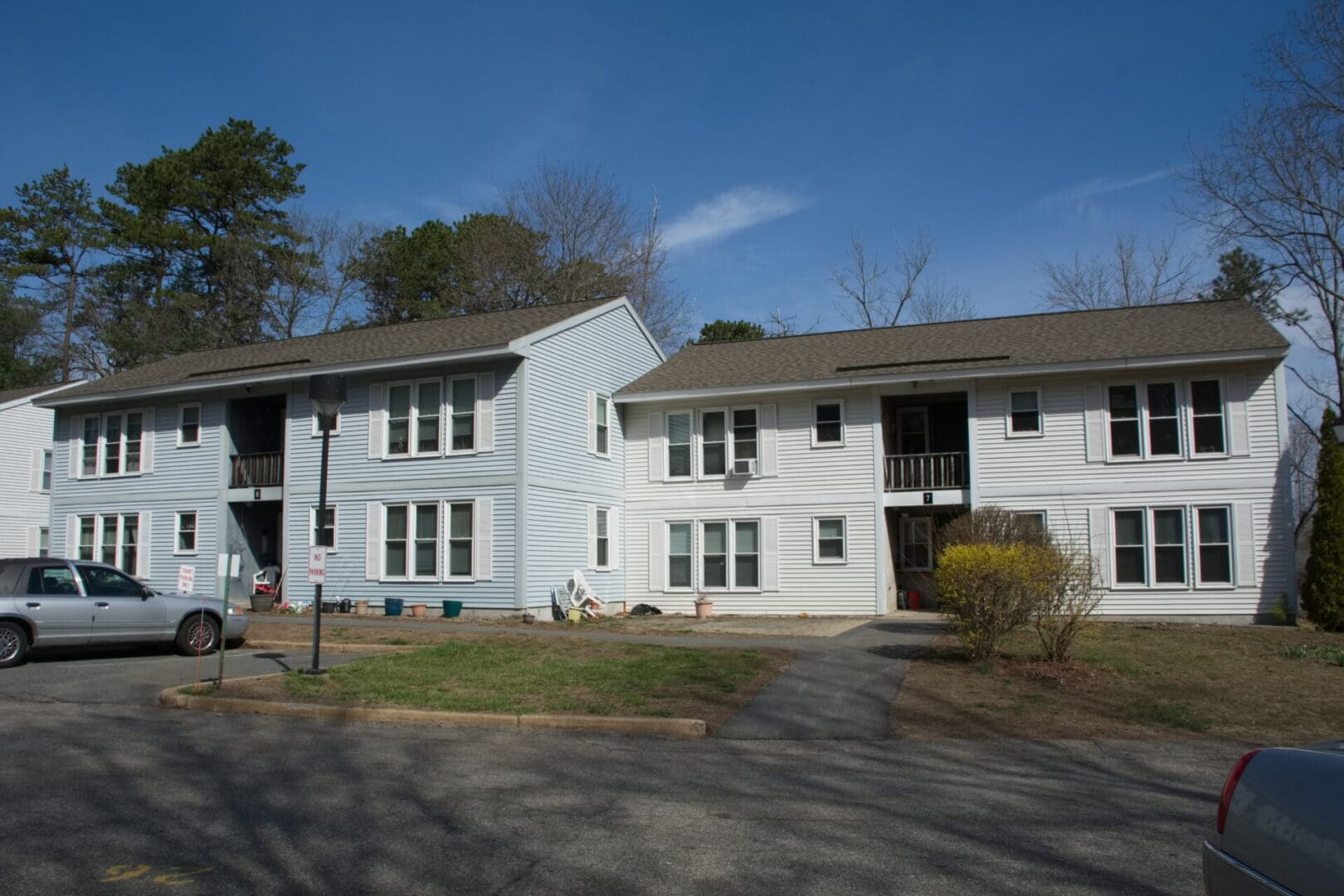 A large white building with many windows and trees